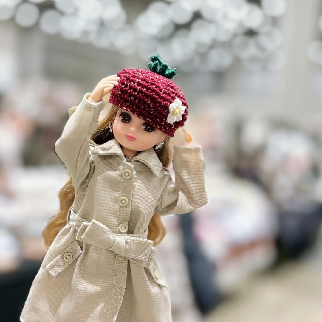 blonde Licca-chan doll wearing a knit hat that looks like a strawberry