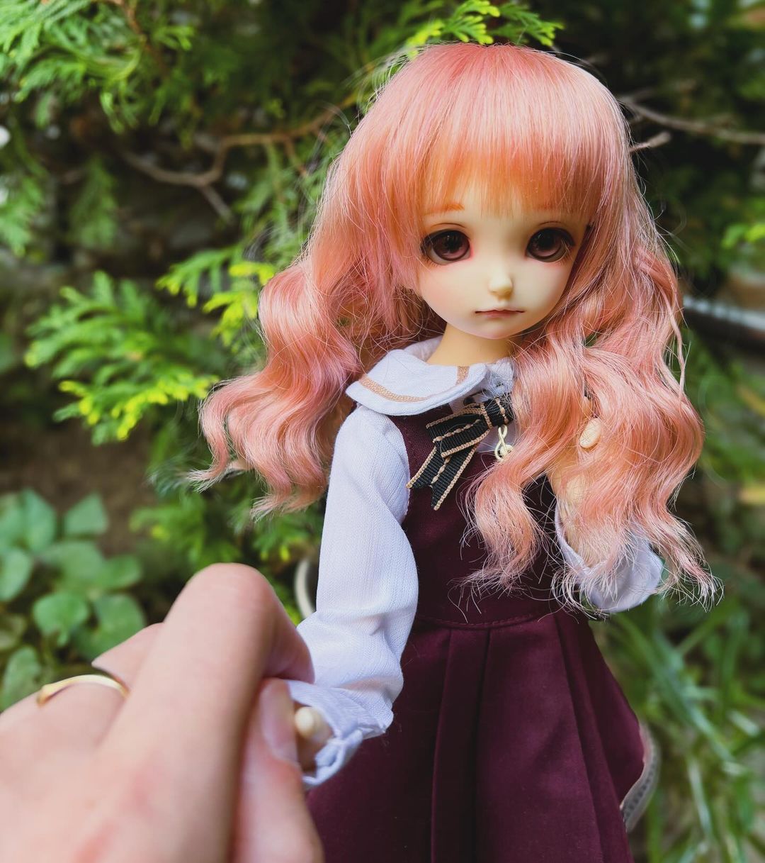 45cm BJD girl with pink hair and maroon eyes, wearing a cute dress